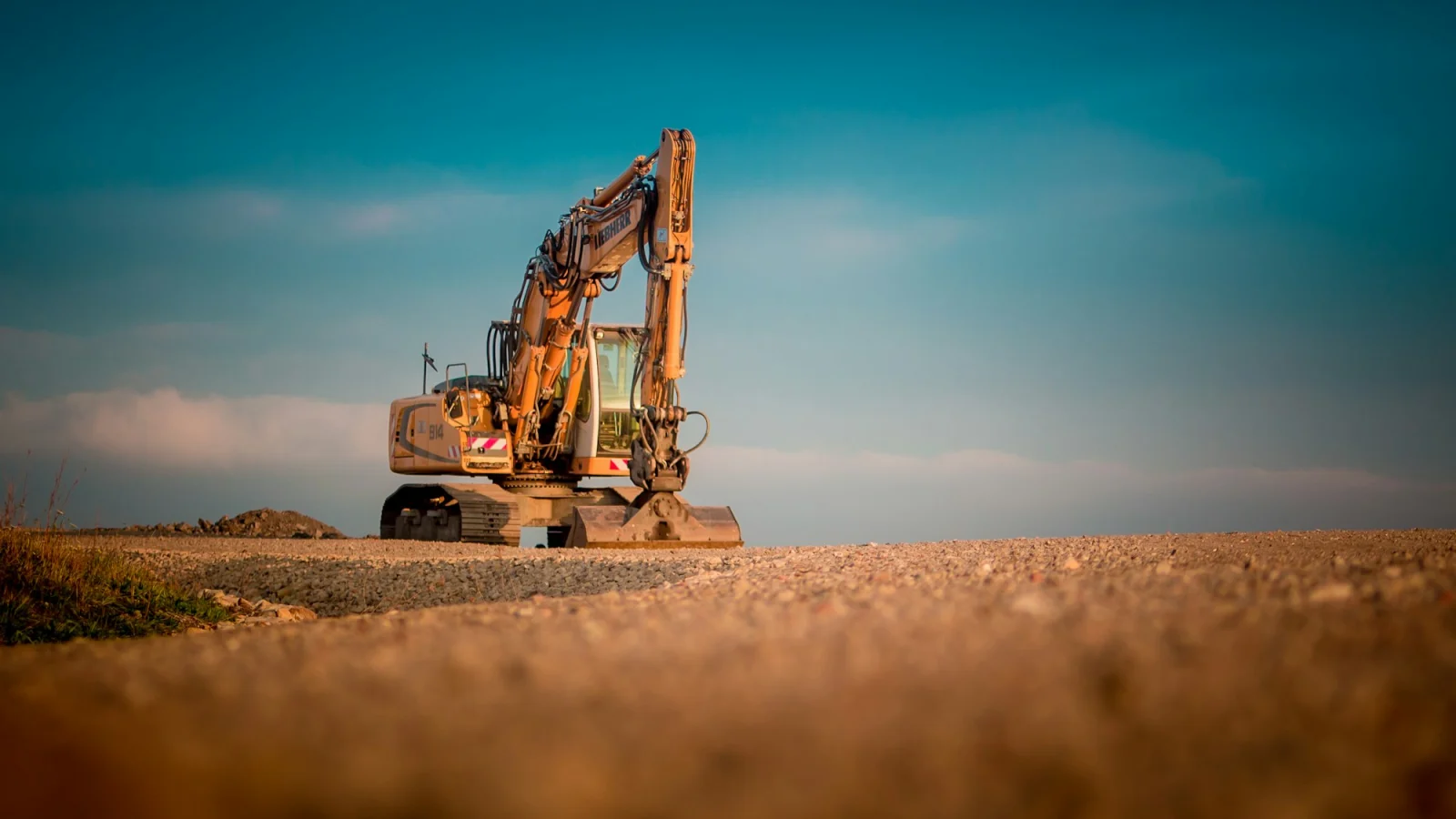 Yellow and black excavator on brown sand during daytime