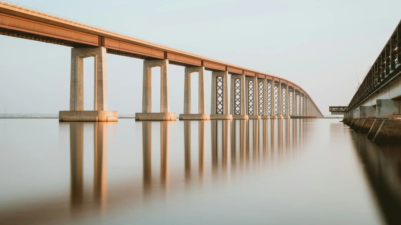 Brown wooden bridge over body of water